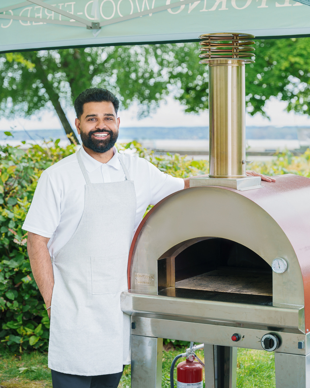 Chef Uttam Khangura with wood-fired oven